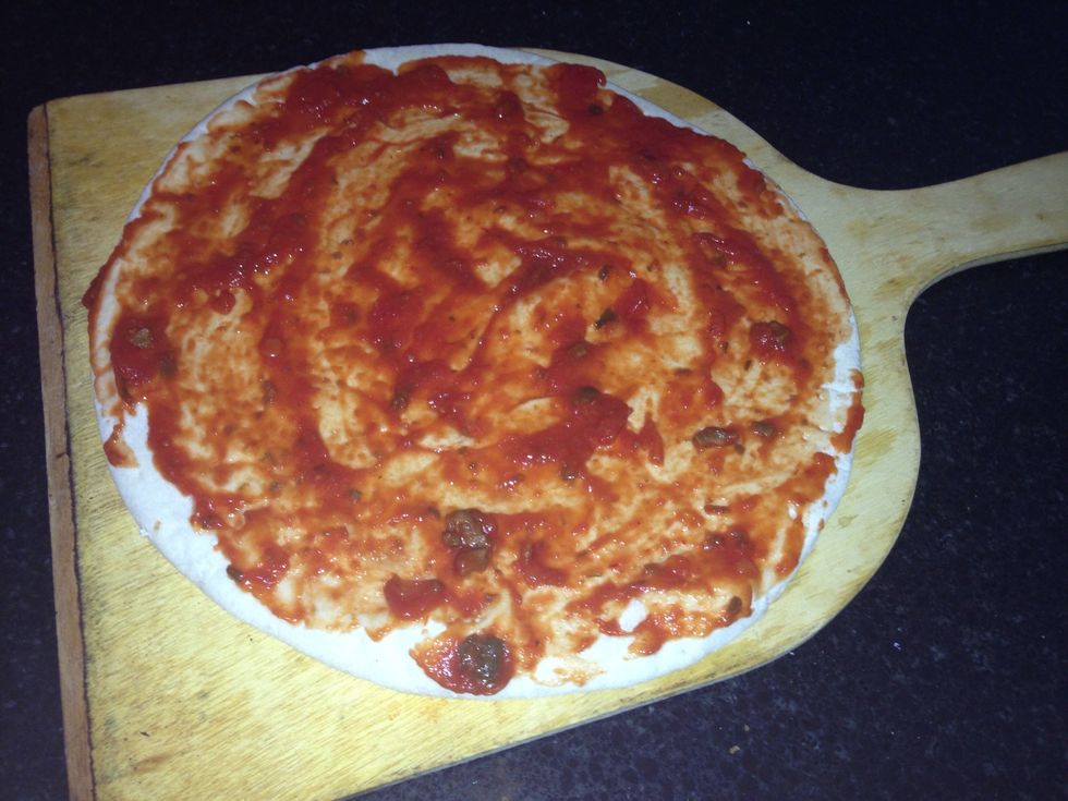Spread  your pizza sauce on