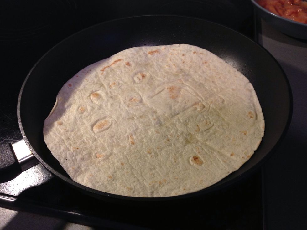 Sprey your other frying pan and put on tortilla, let it get a nice tan from one side