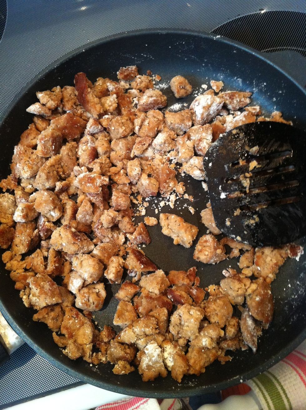 Sprinkle 1/4 cup flour over the cooked sausage and stir until all of the sausage has a flour coating.