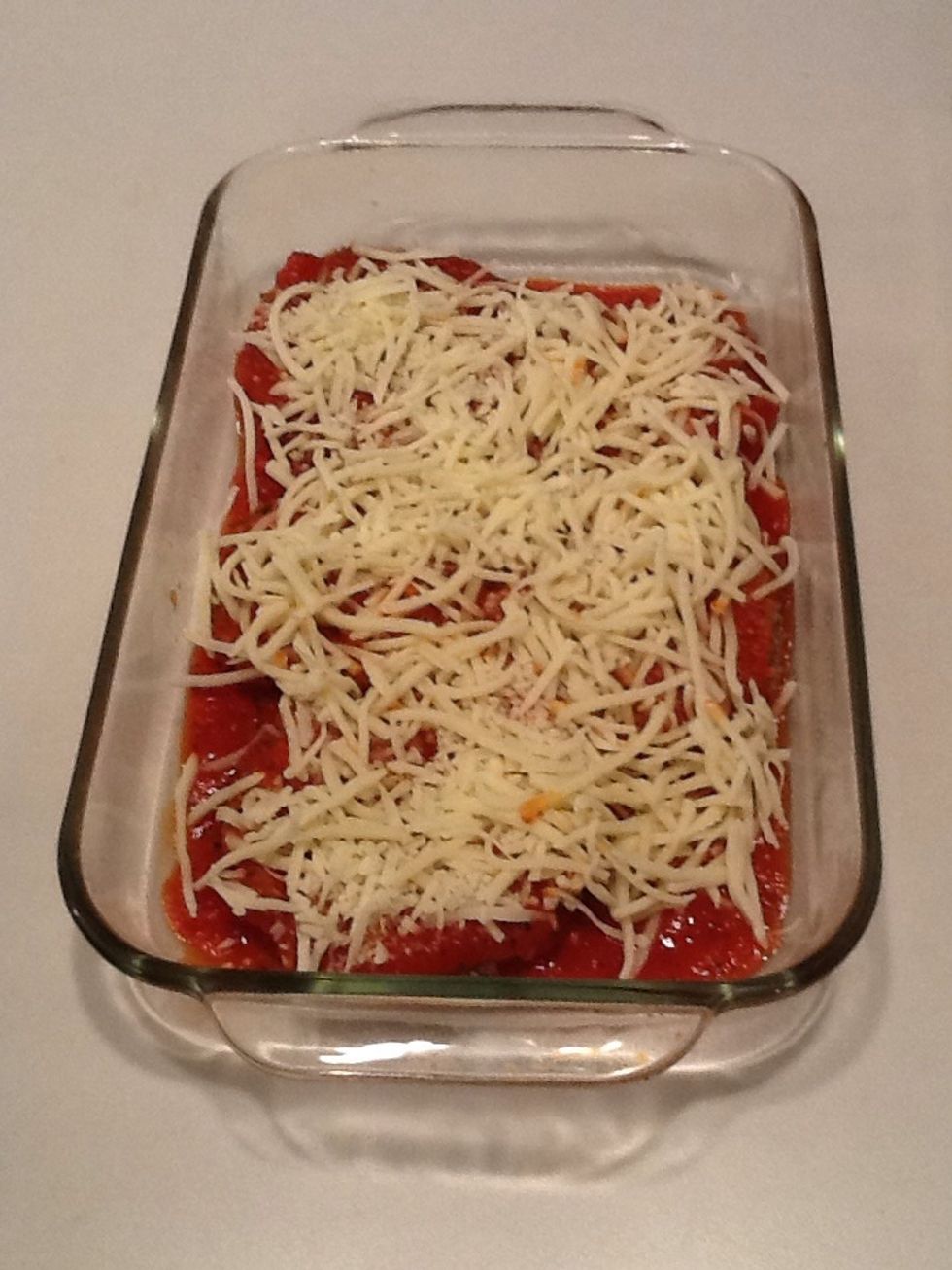 Sprinkle 1 cup of shredded mozzarella cheese over the sauce.