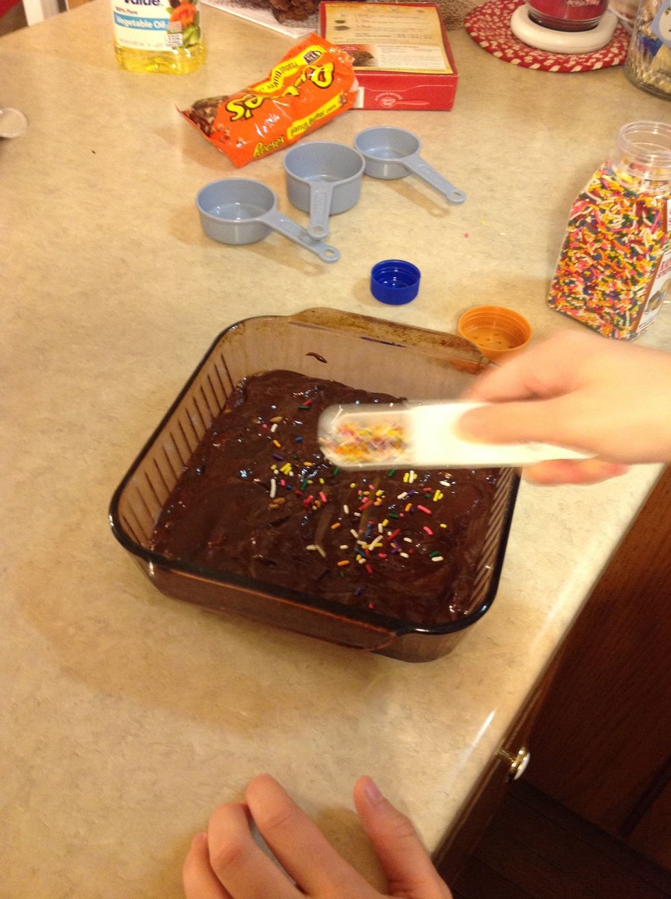 Sprinkle 1 Tbsp of rainbow sprinkles on top of brownie mix.
