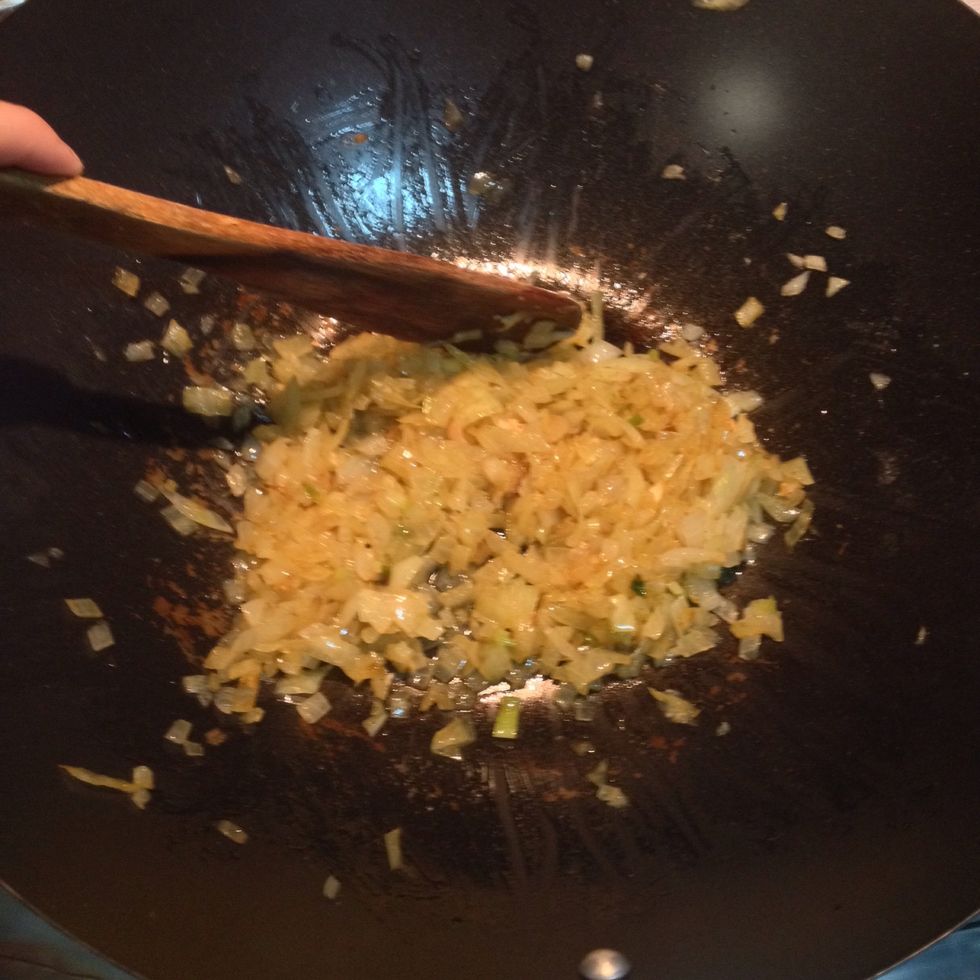 Sprinkle 1 teaspoon salt, 1/2 teaspoon pepper, curry powder, garlic and ginger over the onions, reduce heat to low, and cook gently 5 minutes until onions are softened and translucent.