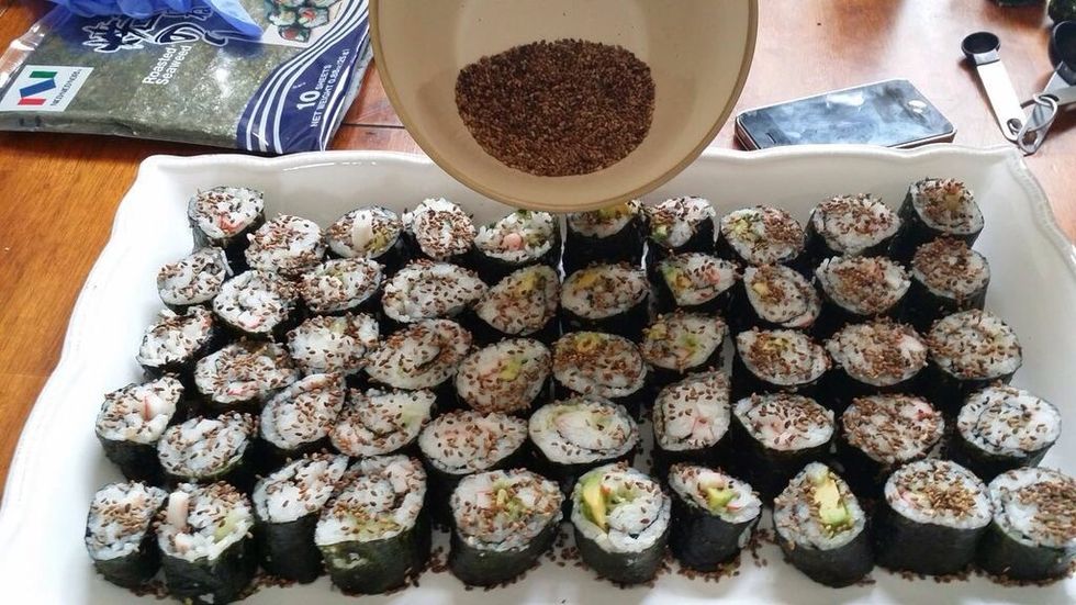 Sprinkle 2 tablespoons of sesame seeds over the sushi. This step is more for appearance rather than flavor.
