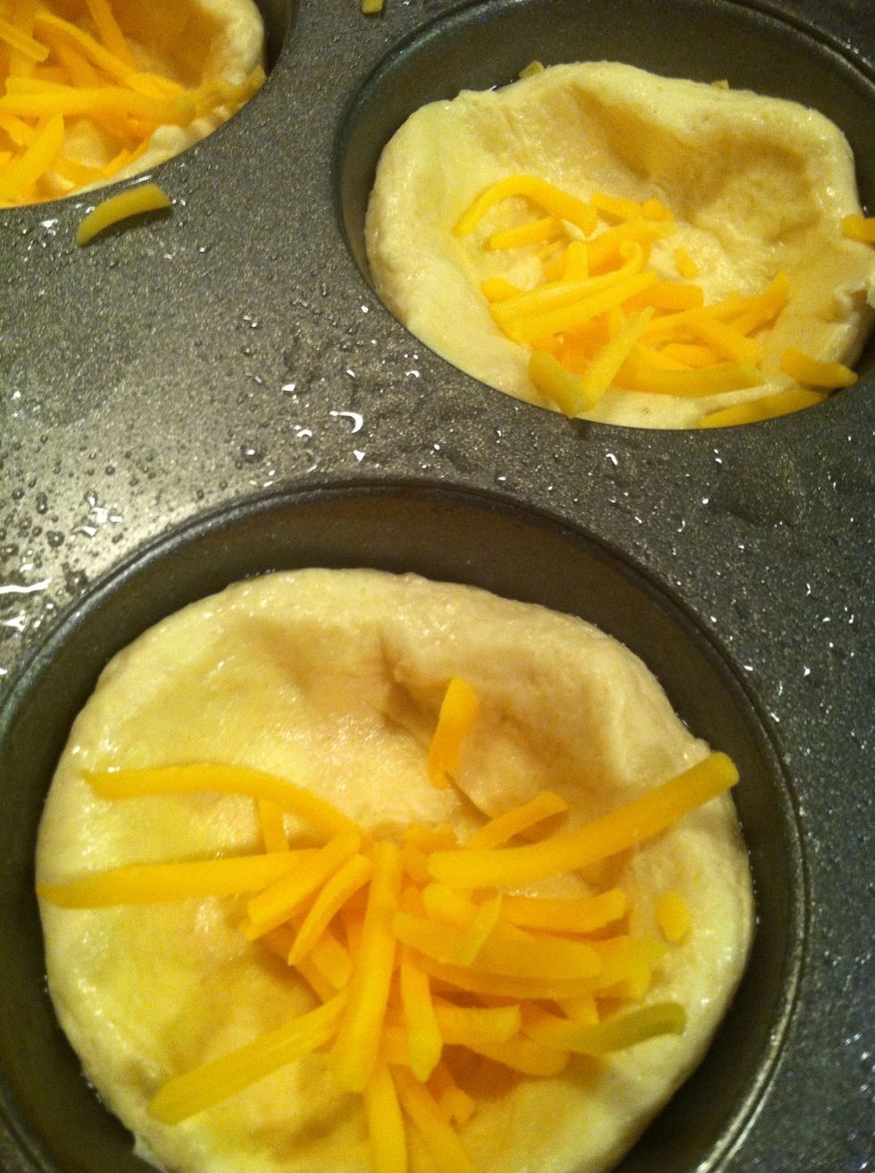 Sprinkle a little cheese into the cups.