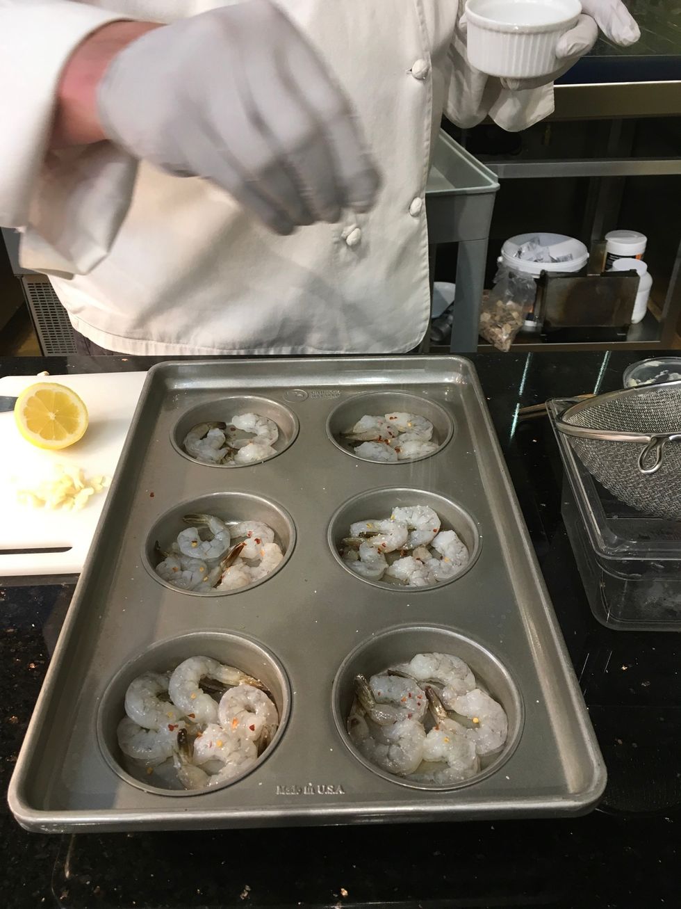 Sprinkle a pinch of salt over the shrimp in each section of the pan.