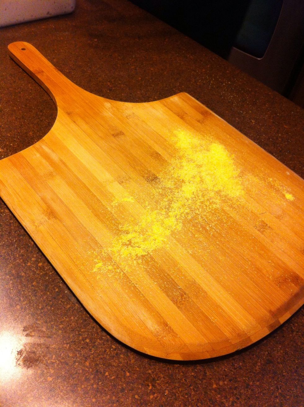 Sprinkle a pizza peel with some cornmeal