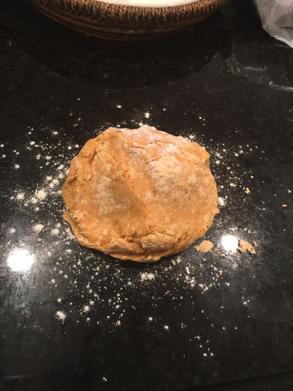 Sprinkle all-purpose flour lightly on the clean countertop or board and place the dough on it.