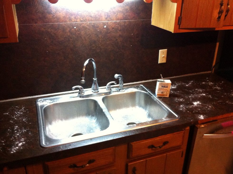 Sprinkle Baking Soda all over the sink and countertop.