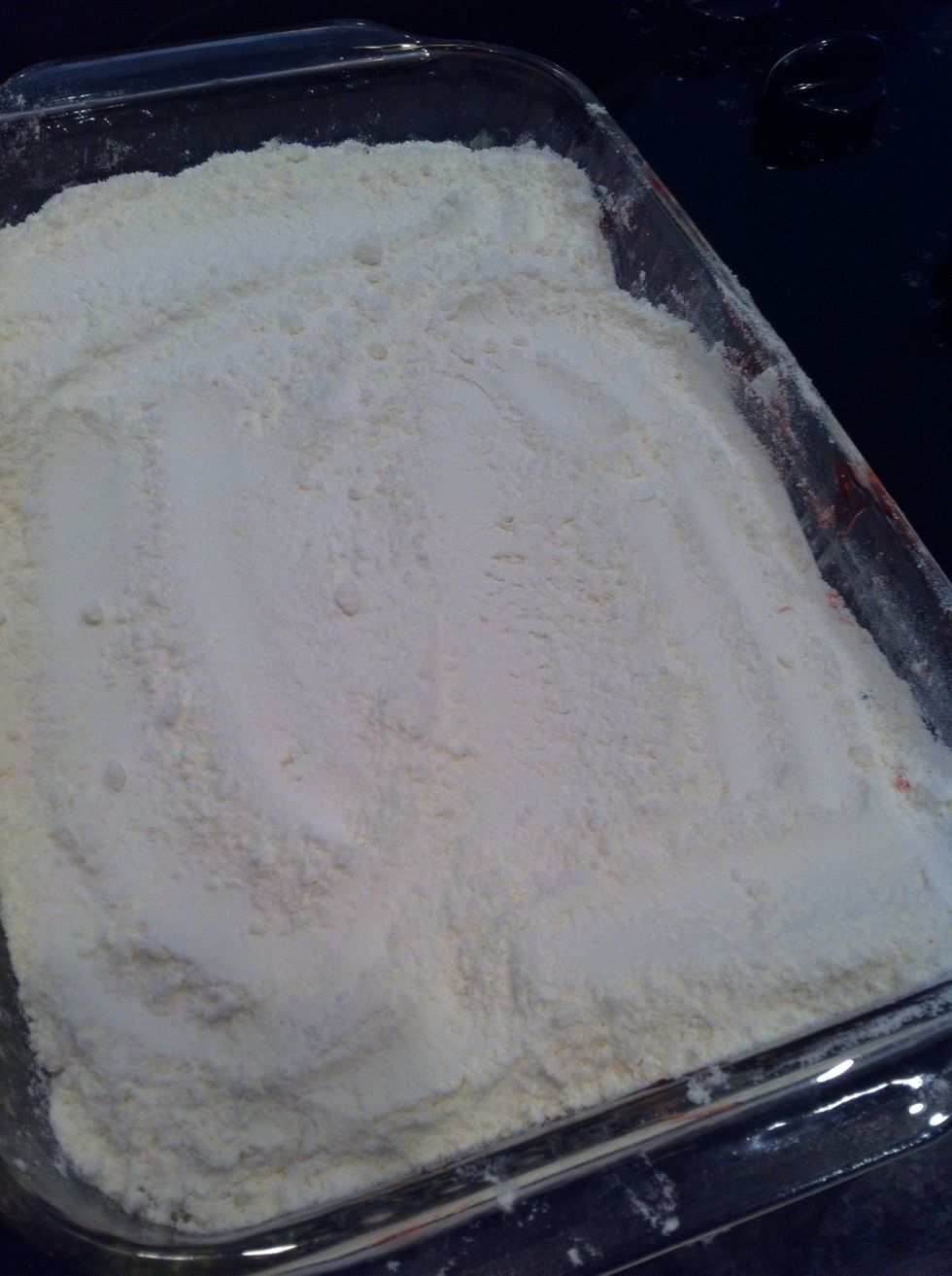 Sprinkle box of dry yellow cake mix on top of cherry and pineapple