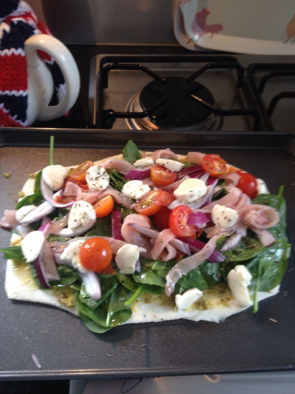 Sprinkle dried oregano and oil onto the bake before putting into the oven