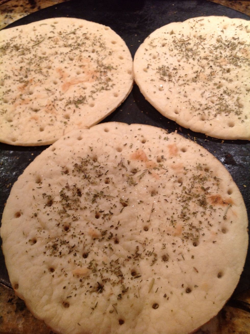 Sprinkle each crust with dried Italian seasoning for an authentic pizza flavor. Some cooks drizzle the crust with olive oil, but I skip that step to reduce calories. You'll never miss it!