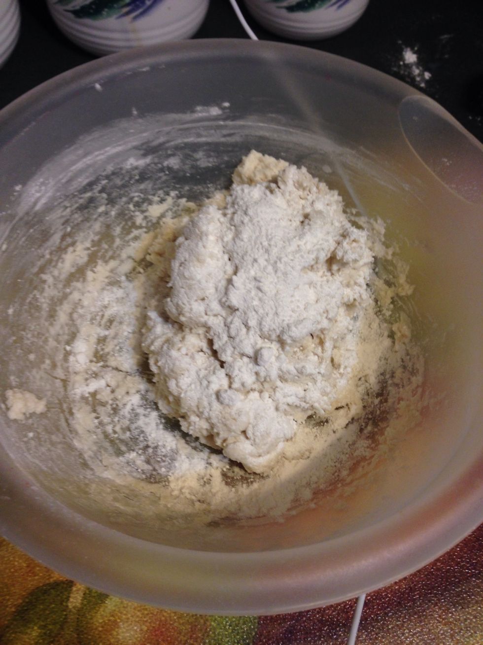 Sprinkle enough flour on top of dough because it is sticky! (so you can handle it).    Scoop out enough to make a biscuit, form in hand and put on greased cookie sheet