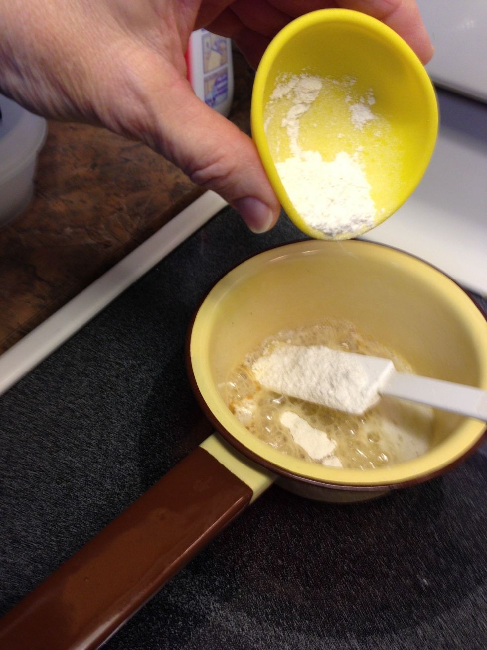Sprinkle flour into melted butter and stir to mix.