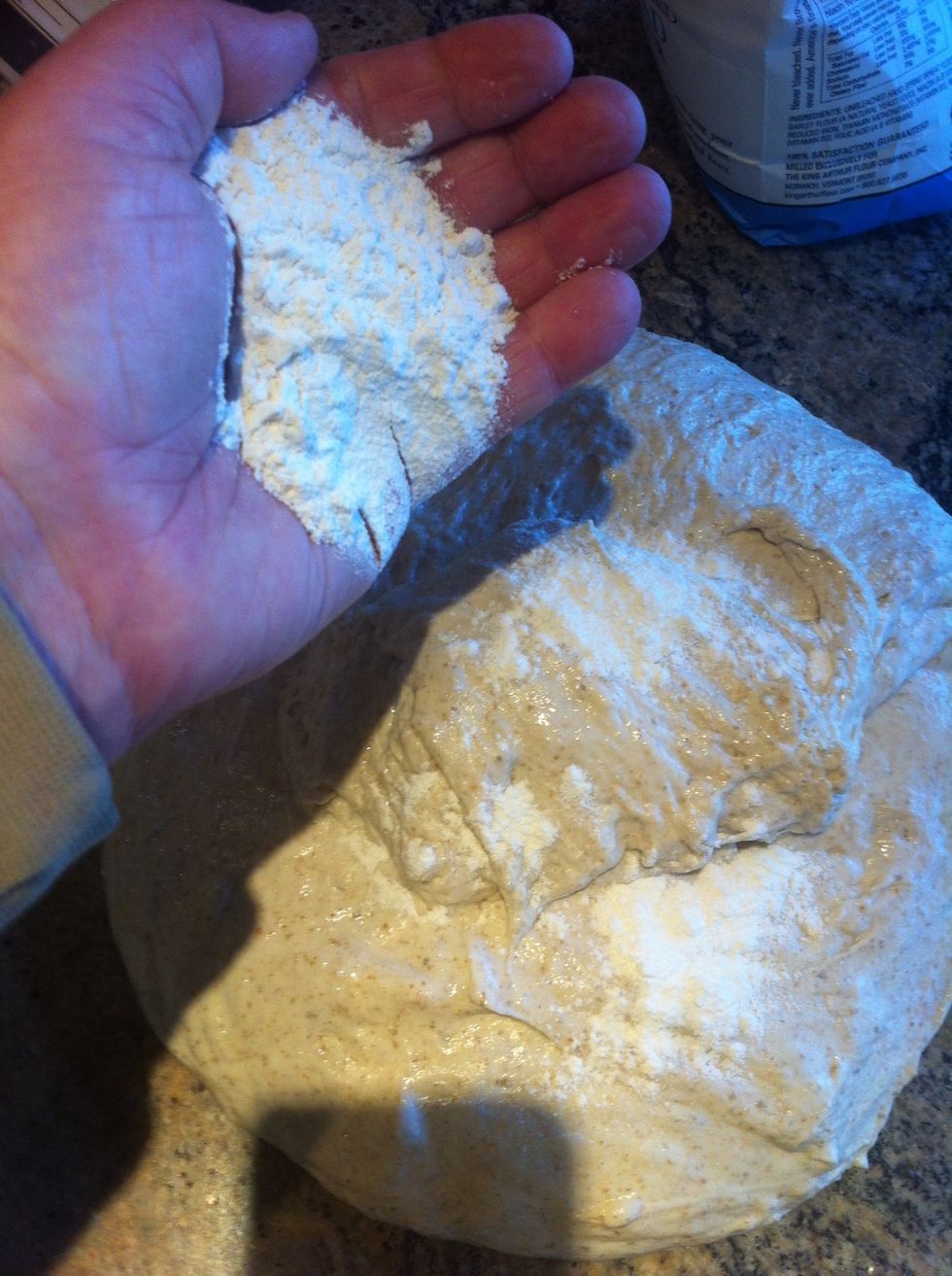 Sprinkle flour lightly over the top of the dough.