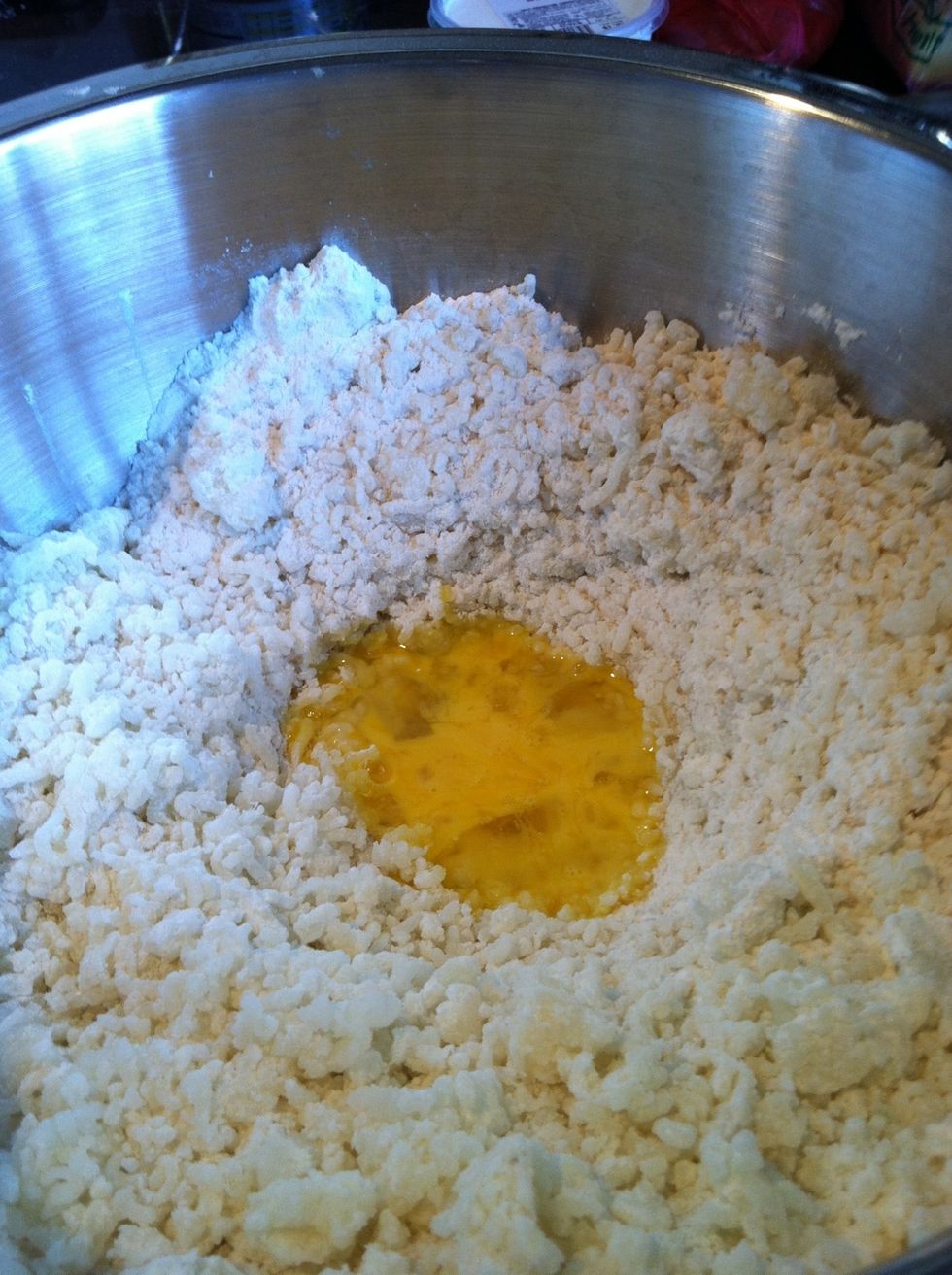 Sprinkle flour over potatoes and make a well and add salt and eggs
