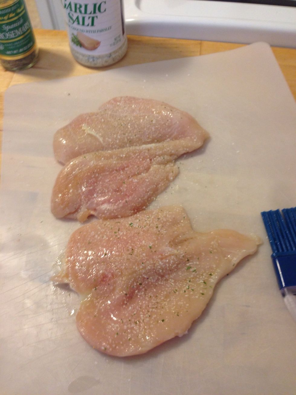 Sprinkle garlic salt on both sides of the chicken breast.