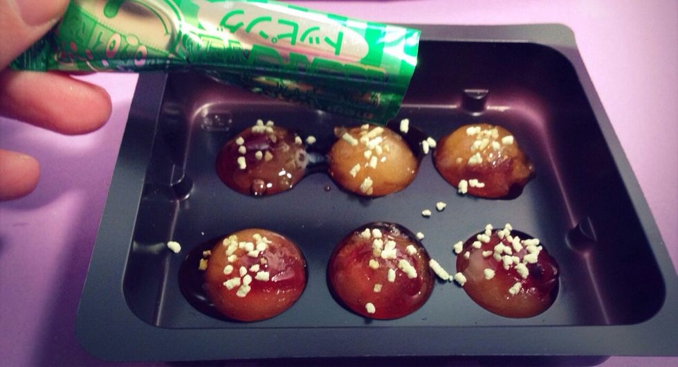 Sprinkle Green sprinkles on top of the Syrup covered Takoyaki