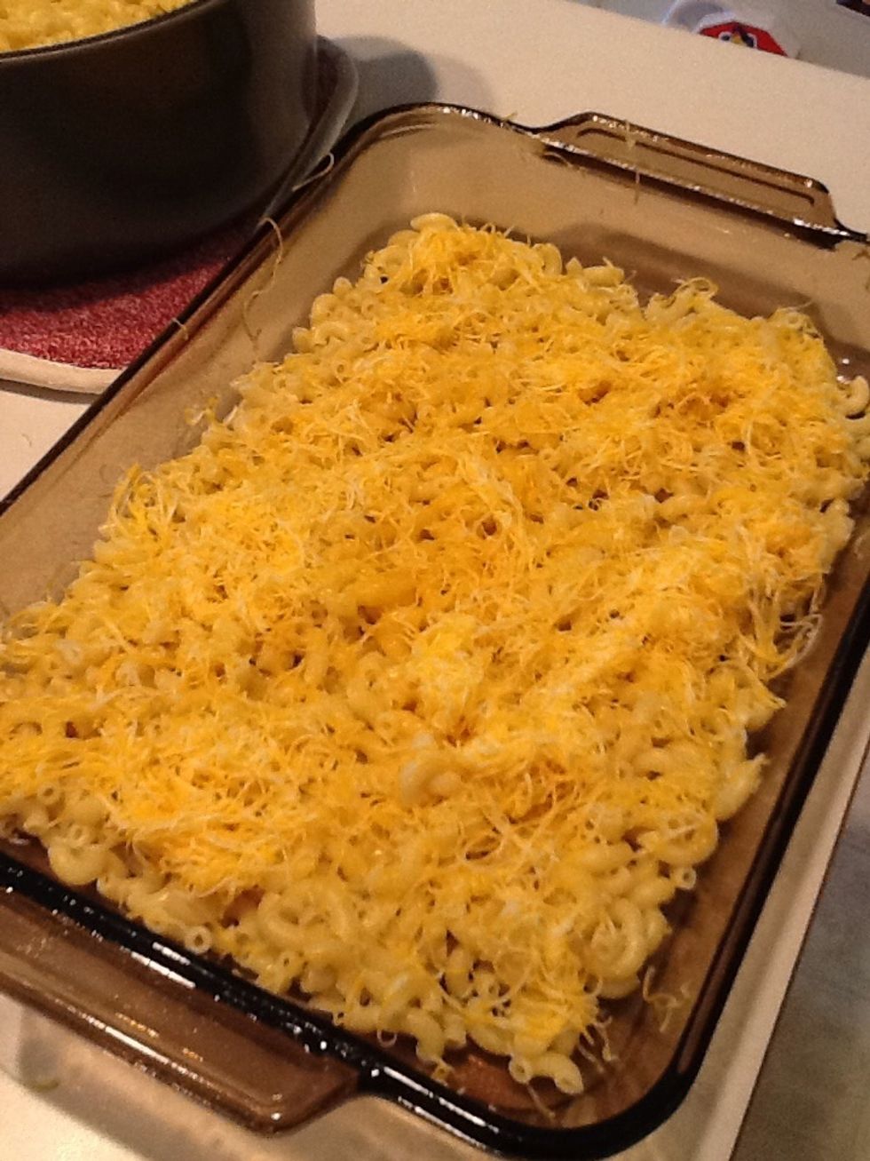 Sprinkle half the cheese on top of the macaroni.  Then repeat by adding the rest of the macaroni, then the rest of the cheese.