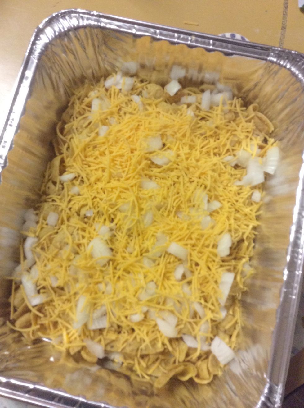 Sprinkle half your cheese and onions over the Fritos