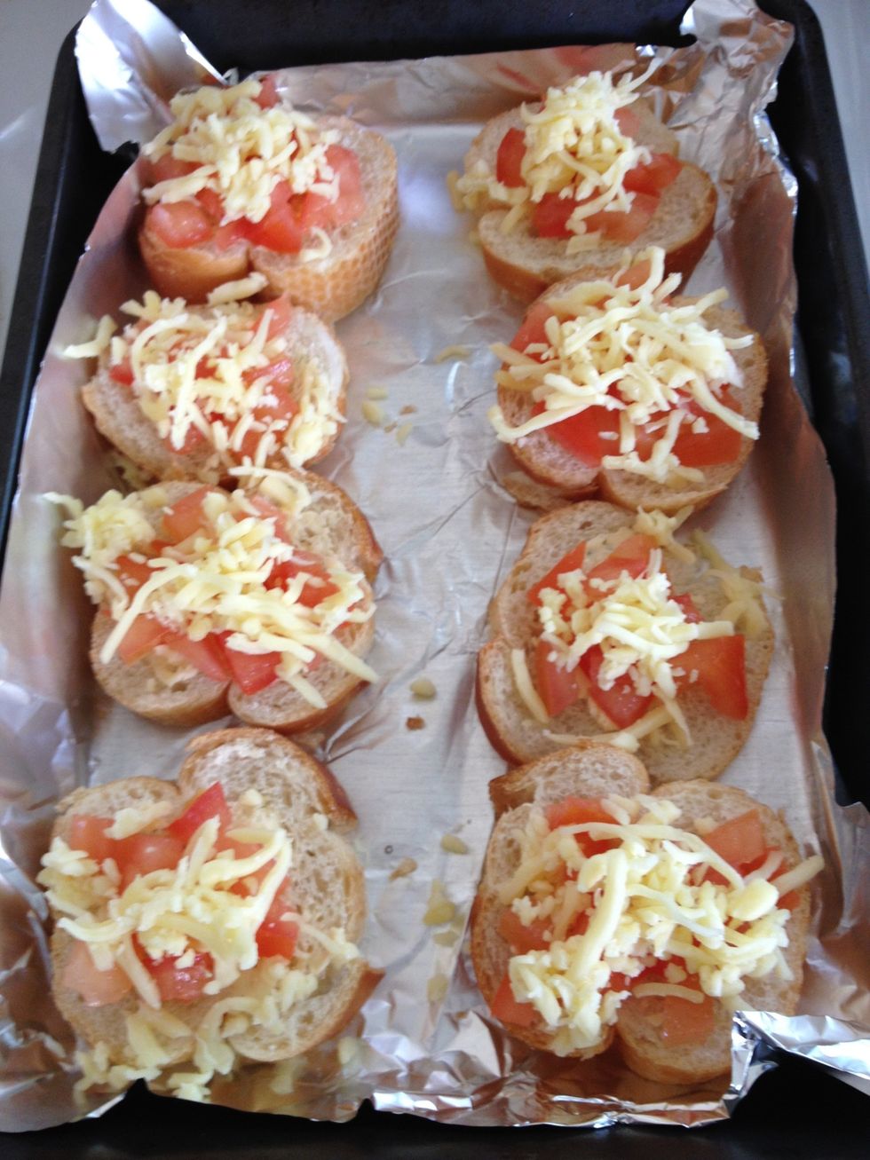 Sprinkle mozarella cheese crumbs on top. Bake them in the oven with the temperature of 220 Celcius for 15 to 18 minutes