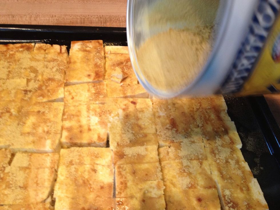 Sprinkle nutritional yeast on the tofu evenly. If you make it too thick the yeast will just burn in little piles.