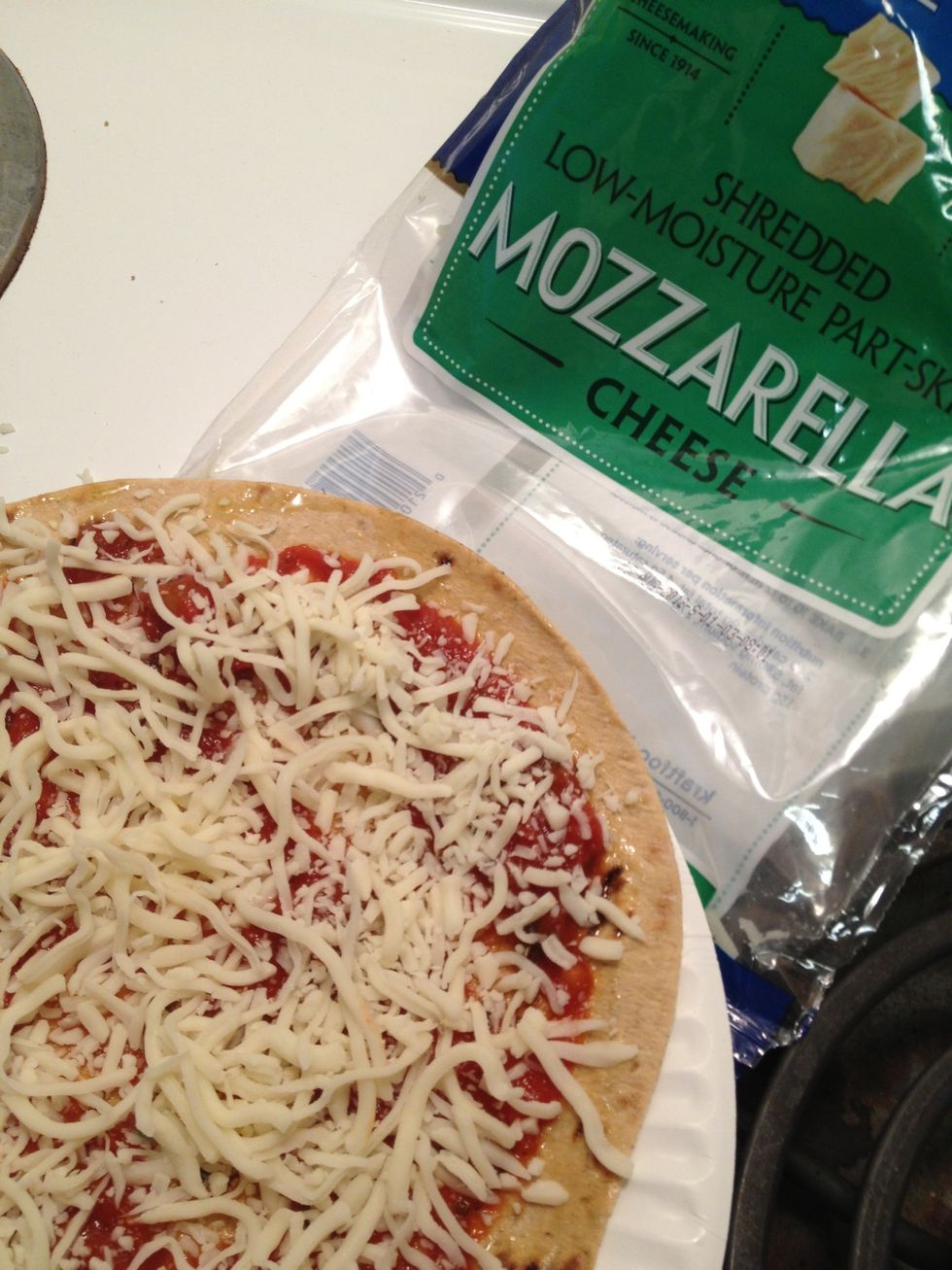 Sprinkle on a cup of mozzarella cheese. Don't forget, you can also add toppings like chicken, tomato, onions, hamburger, pepperoni, or whatever you'd like. I just don't have that stuff right now.