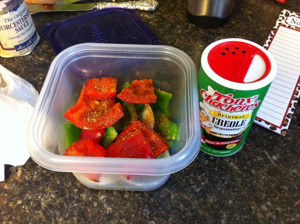 Sprinkle peppers and onion with Tony's seasoning (use any seasoning with spice if you cannot find Tony's) and add olive oil as well as some Worcester.