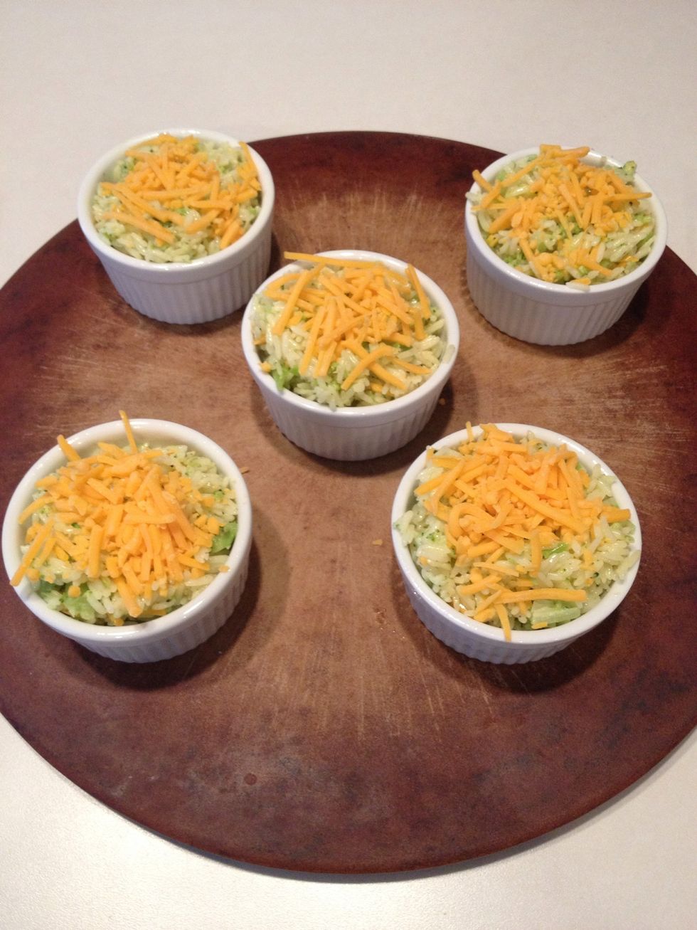Sprinkle remaining cheese on top of the rice cups. Bake in the oven for 25 minutes, or until cheese starts to brown.