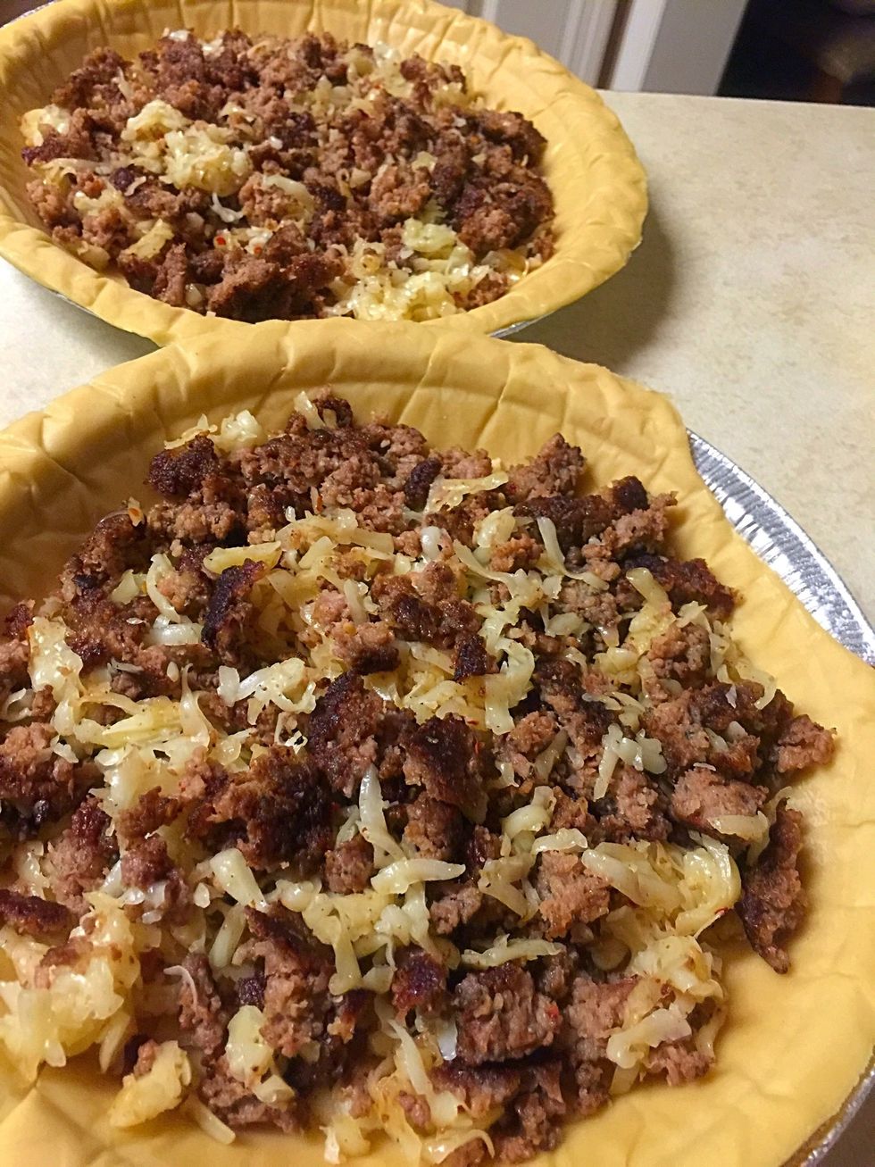 Sprinkle sausage and cheese mixture in pie shells.
