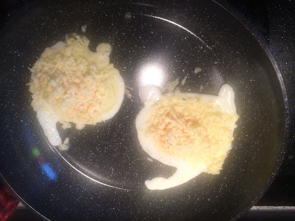 Sprinkle some cheese on top of the eggs.