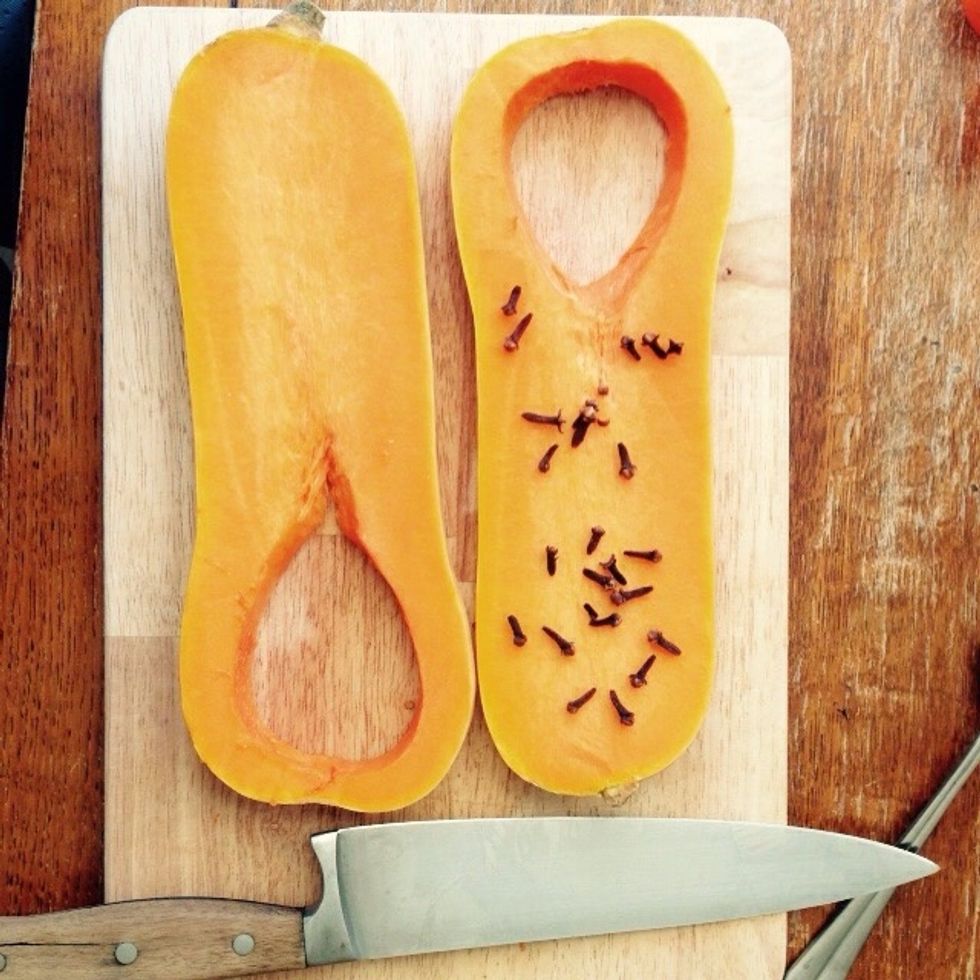Sprinkle some cloves on top of one half.