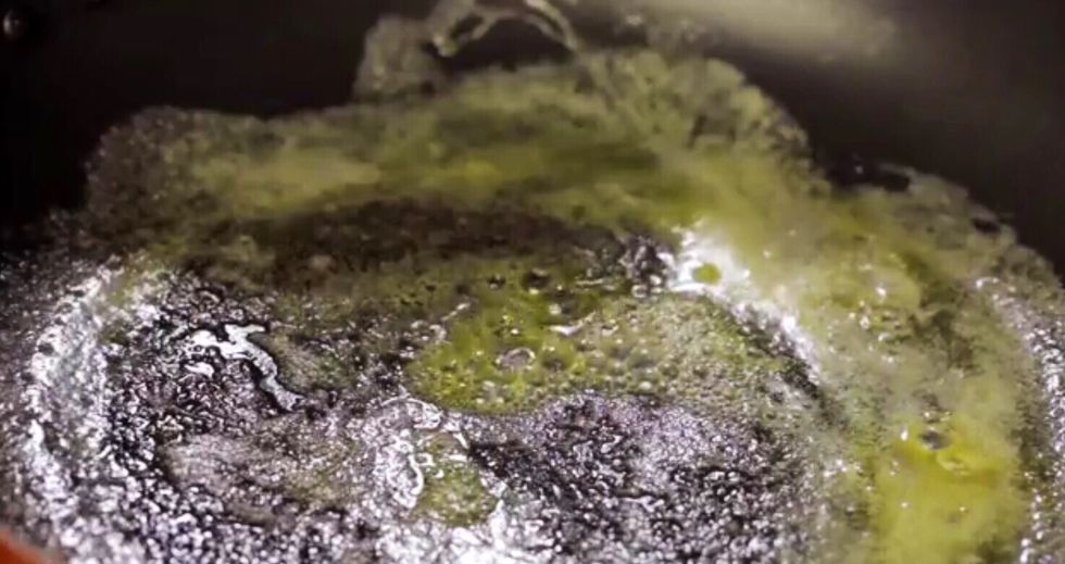 Sprinkle some flecks of water onto the warm pan. If the water starts sizzling or jumping from the pan, it is ready for the batter to be cooked.