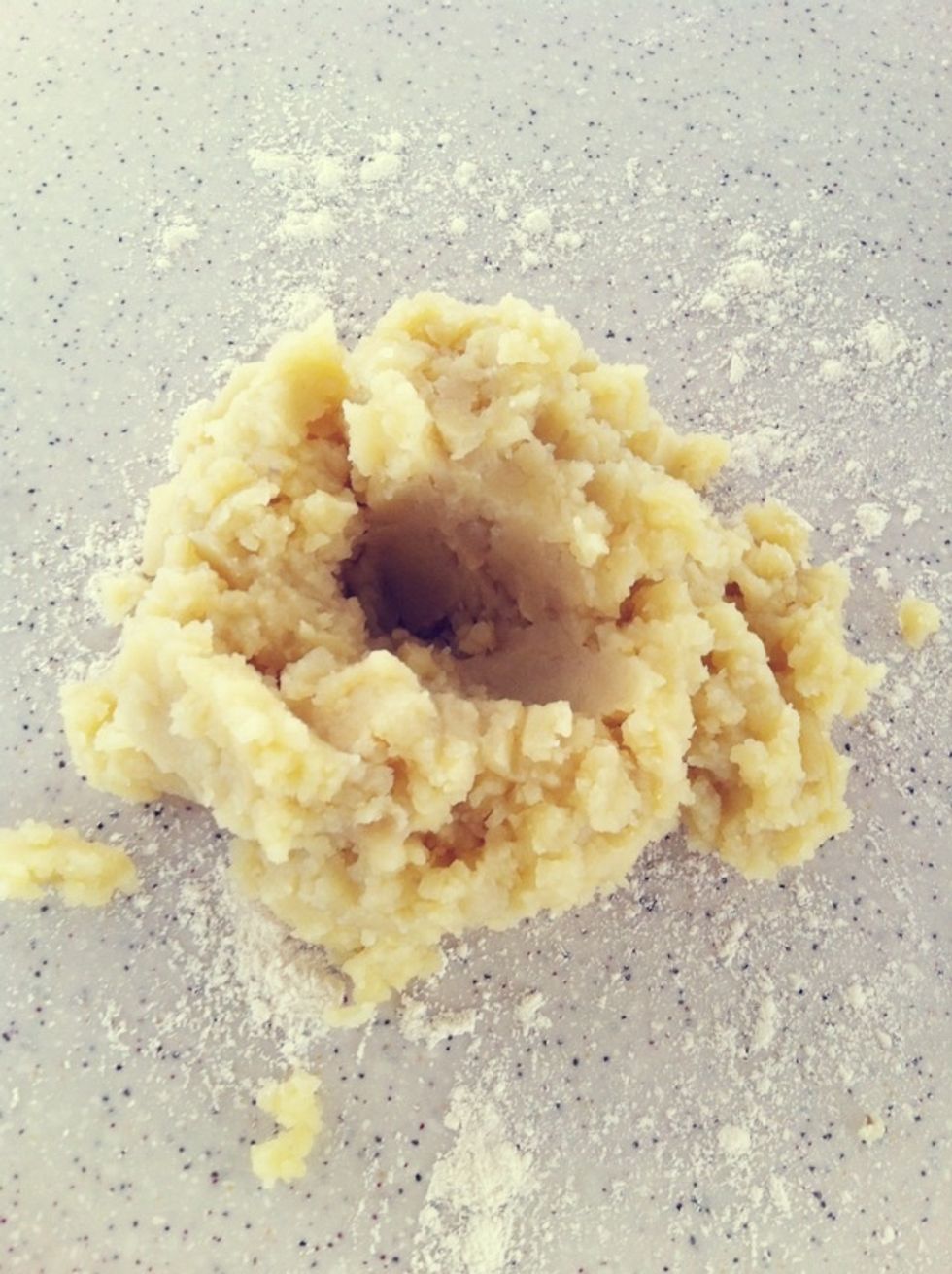 Sprinkle some flour on the working table & place meshed potato on top.