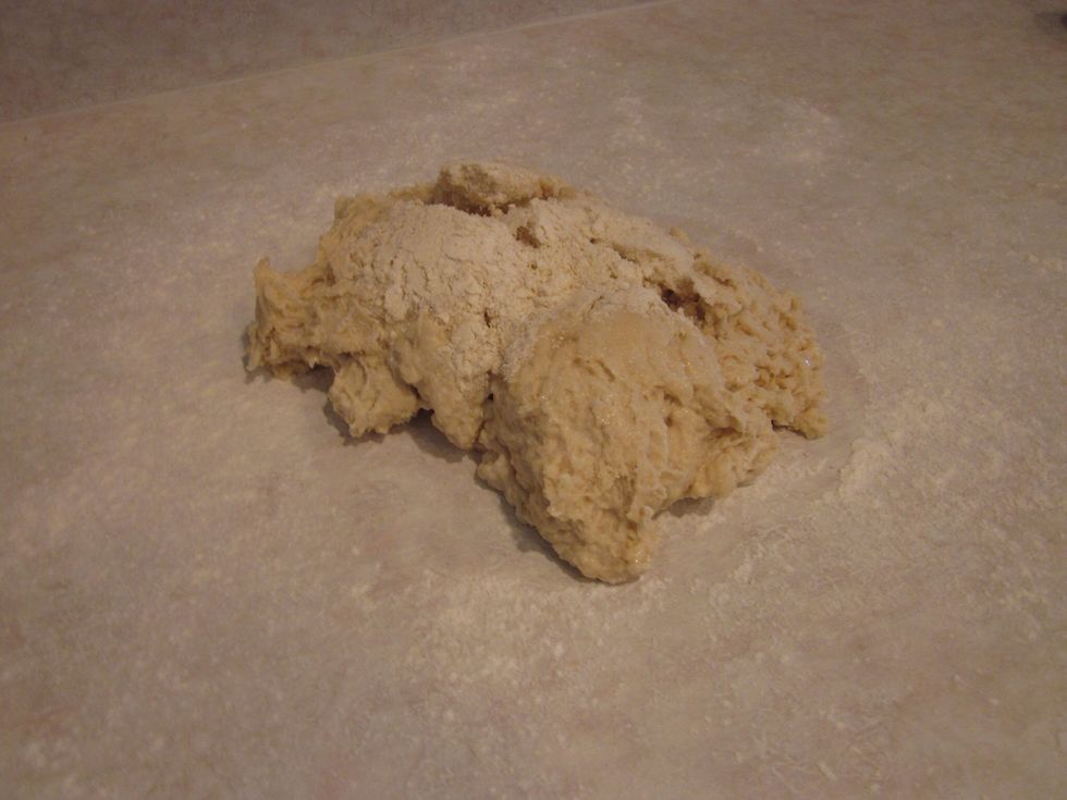 Sprinkle some flour on your workspace and plop the dough right there front and center. It's kneading time. Knead for ten minutes. I'll be adding a guide on how to do that, for now just give it a whirl