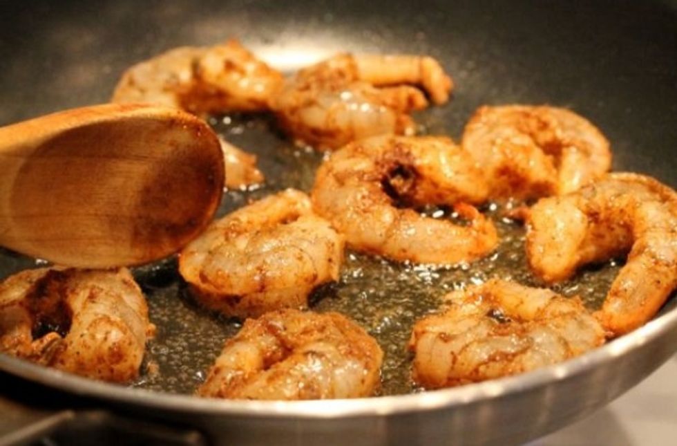 Sprinkle some of the salt and pepper on the prawns then fry them until they're golden.