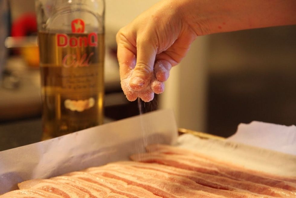 Sprinkle sugar evenly over the bacon strips.