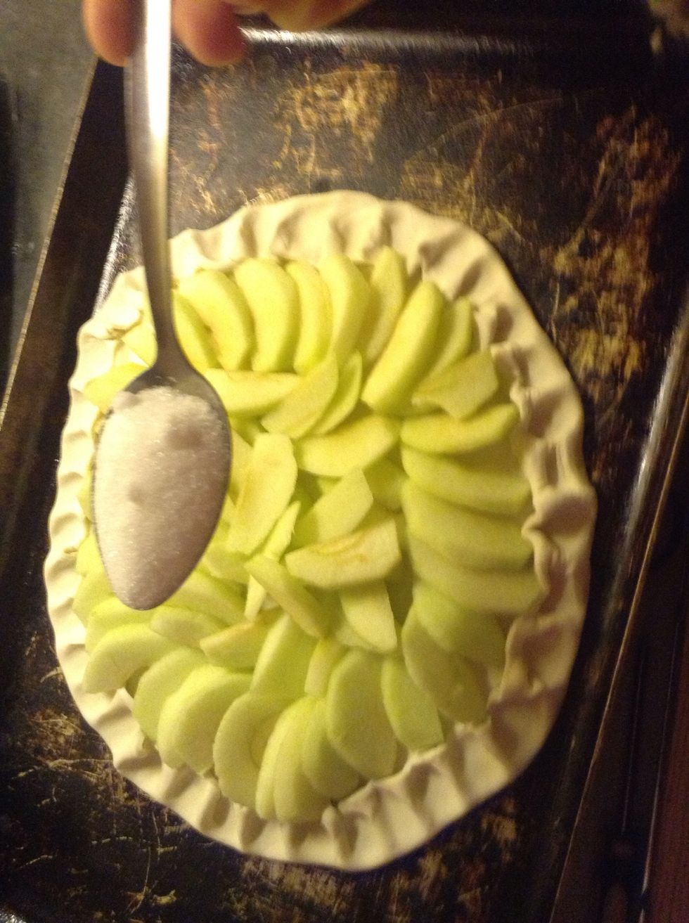 Sprinkle the castor sugar and dot the butter around the apples.