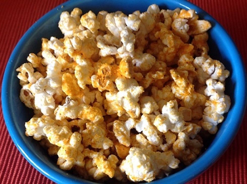 Sprinkle the cheddar powder onto the popcorn but don't put too much or it will be too powdery and it won't taste as good.