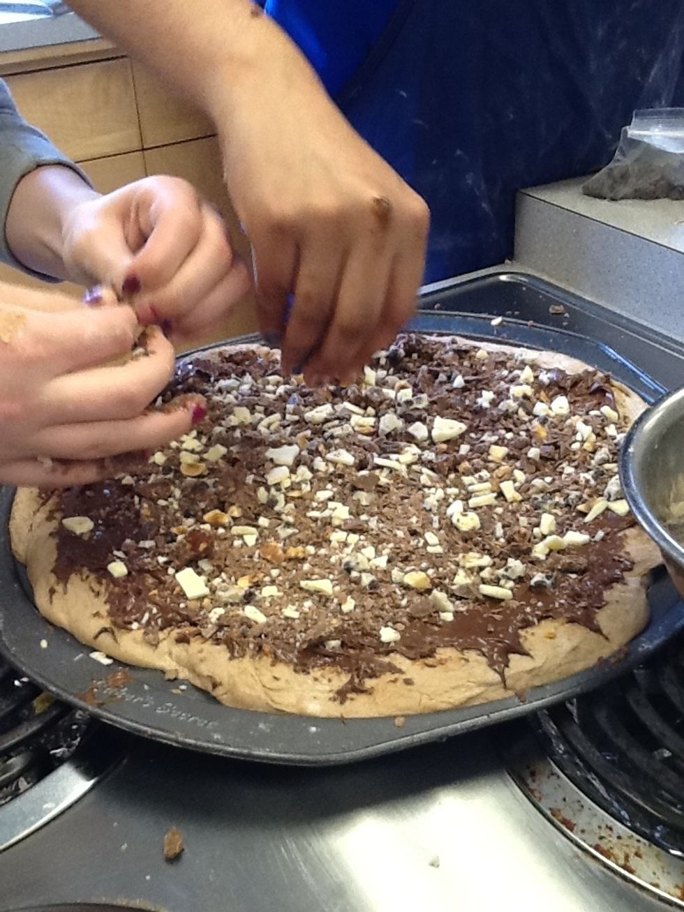 Sprinkle the chocolate on top of the Nutella and cook it.