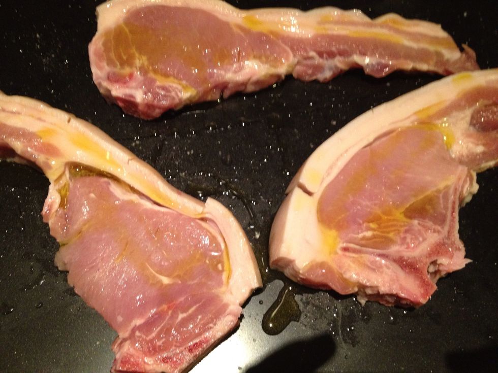 Sprinkle the chops with sea salt and drizzle with olive oil. Do this on both sides, then rub the salt and oil into the meat. Use your hands!