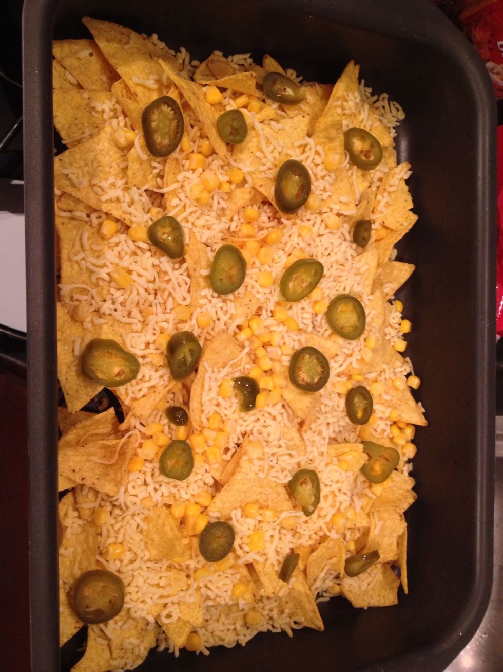 Sprinkle the corn and peppers on the nachos