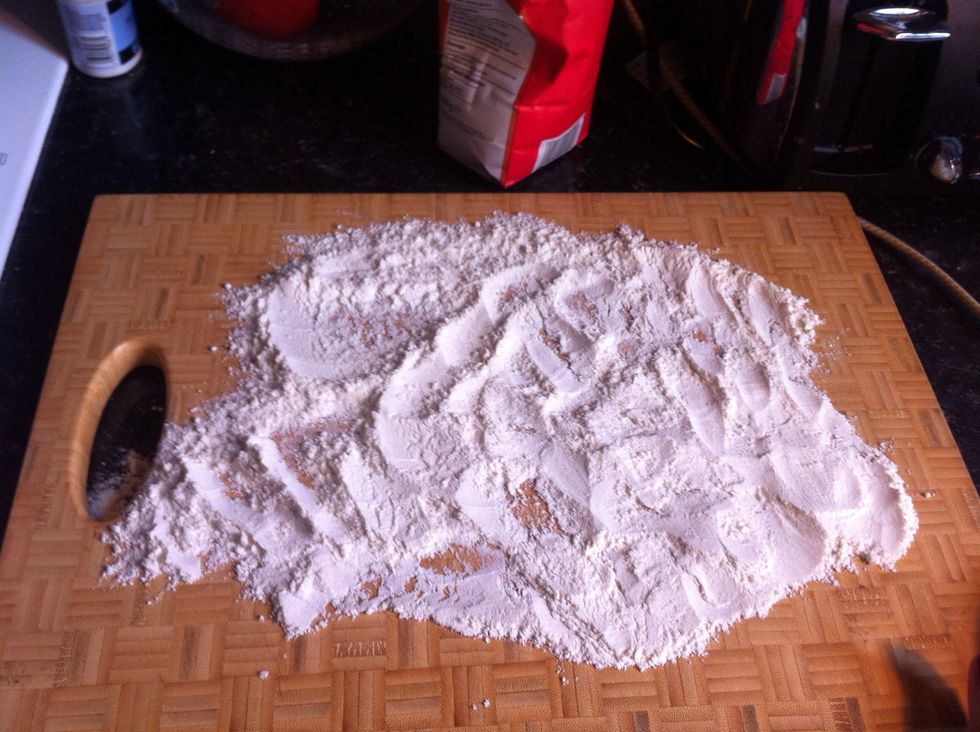 Sprinkle the flour onto the chopping board.