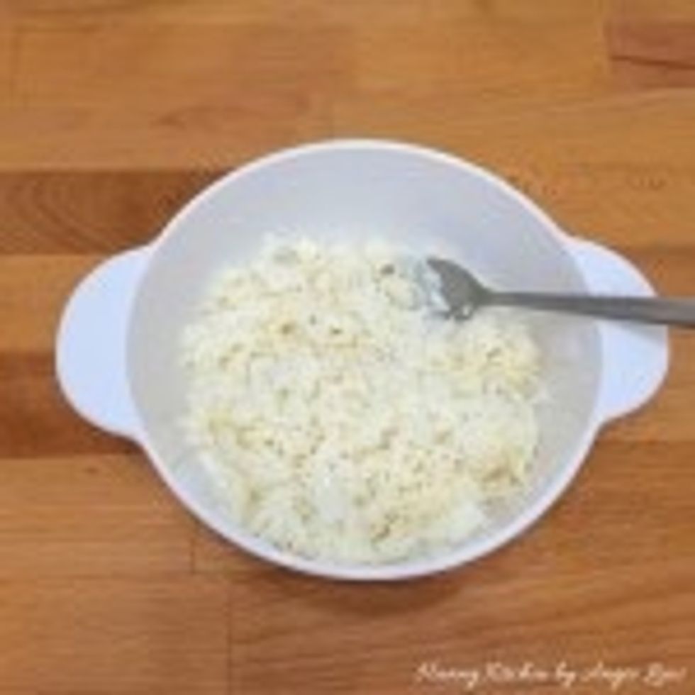 Sprinkle the pounded sweet wine yeast on top of the rice followed by sugar and water. Mix to ensure the ingredients are well combined with the cooled cooked rice.