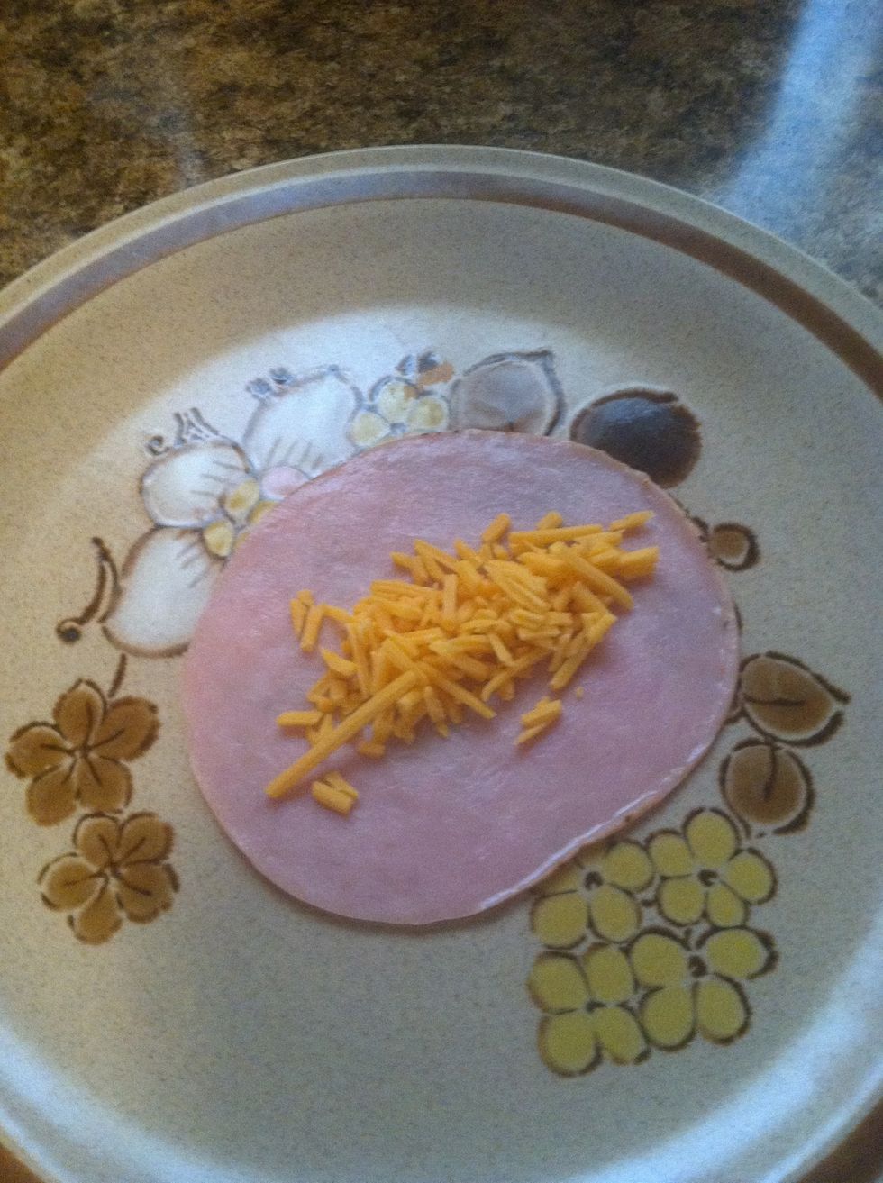 Sprinkle the shredded cheese down the middle of the meat