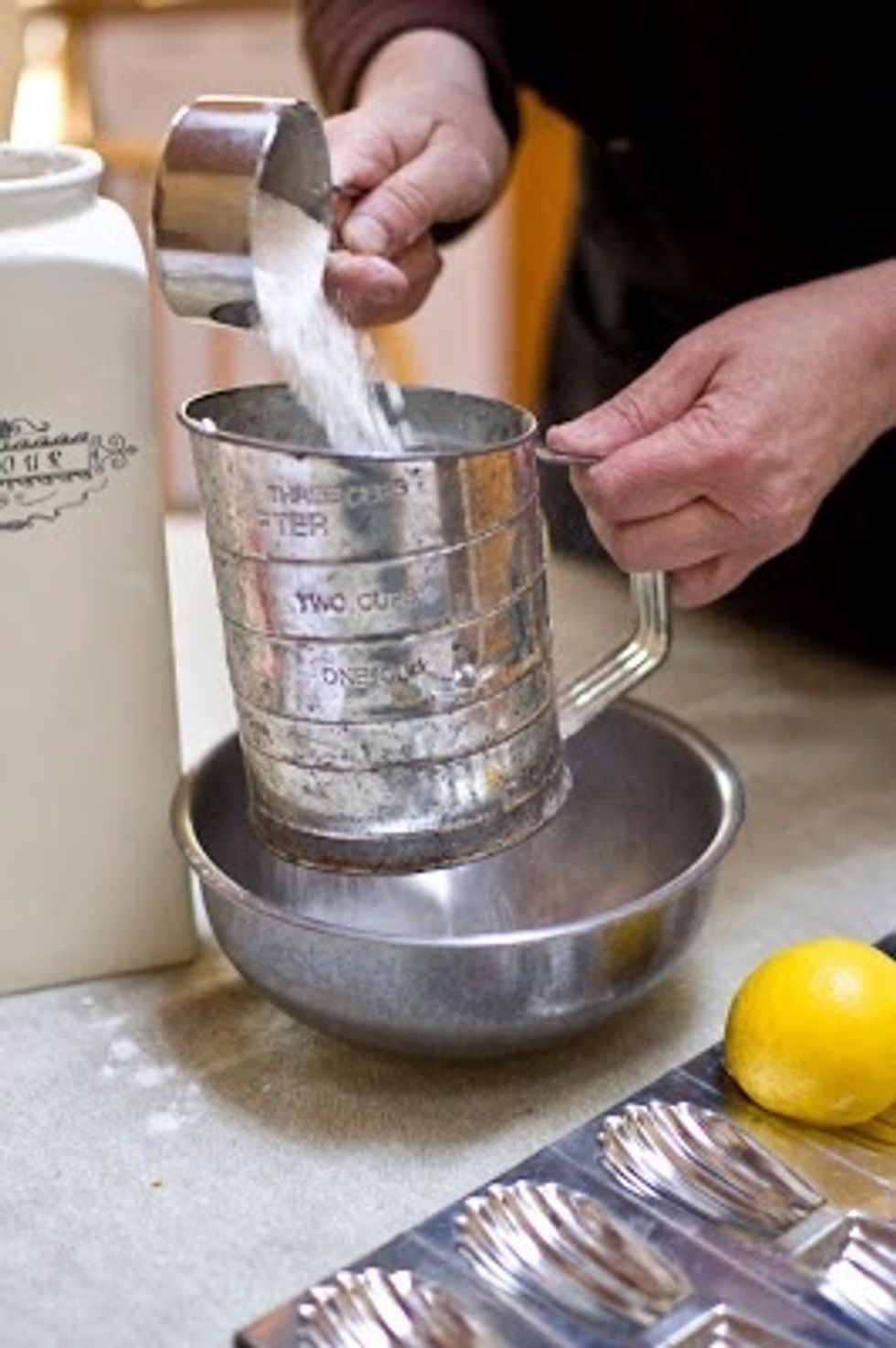 Sprinkle the sifted flour over the mixture and beat it in at low speed.