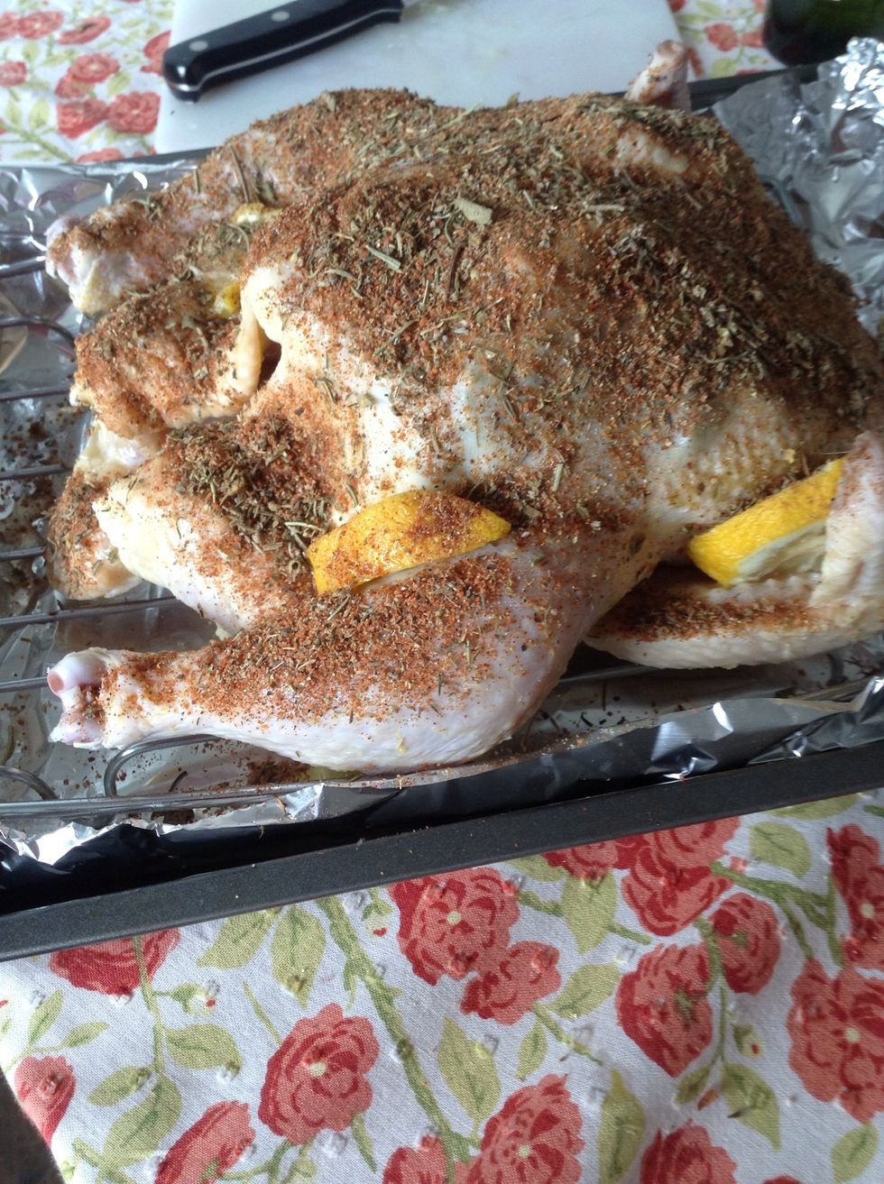 Sprinkle the spice mixture over the whole chicken. You can also cut up potatoes, carrots and onions and place those around the chicken. Add water to the pan to cover the bottom surface.