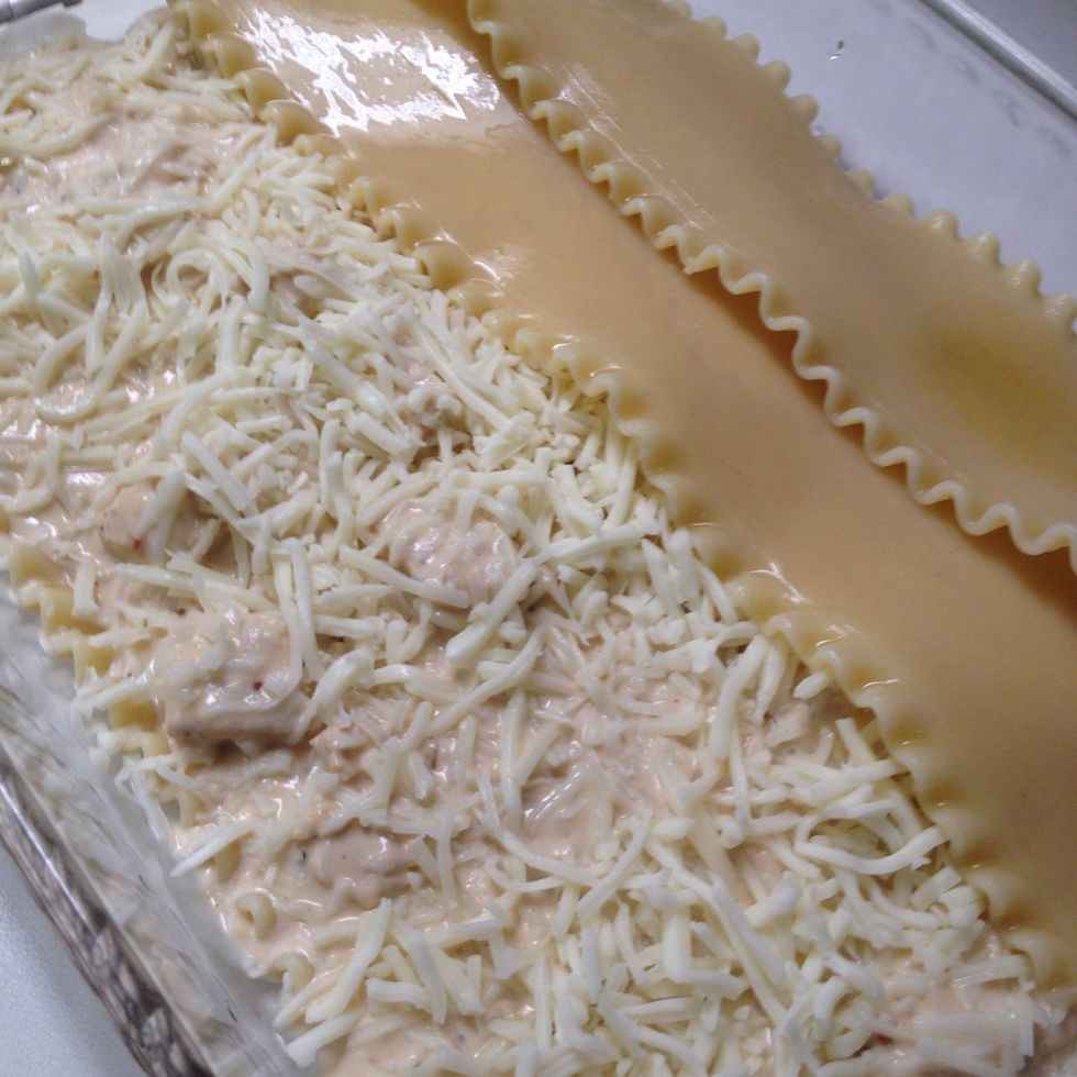 Sprinkle the top with cheese and add next layer of noodles.