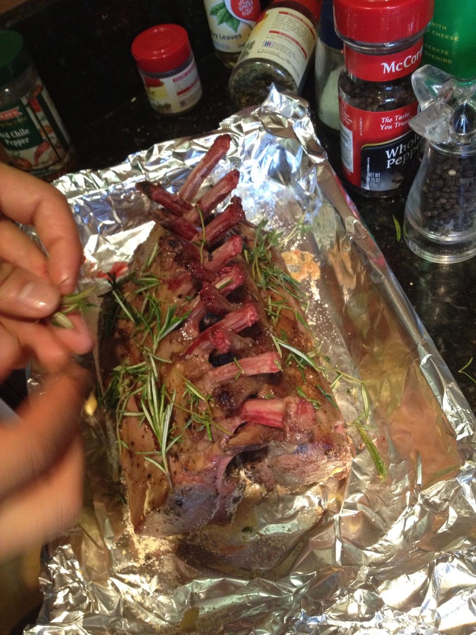 Sprinkle thyme and rosemary onto lamb.