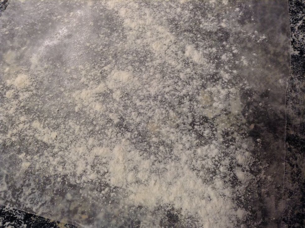 Sprinkle wax paper with flour.
