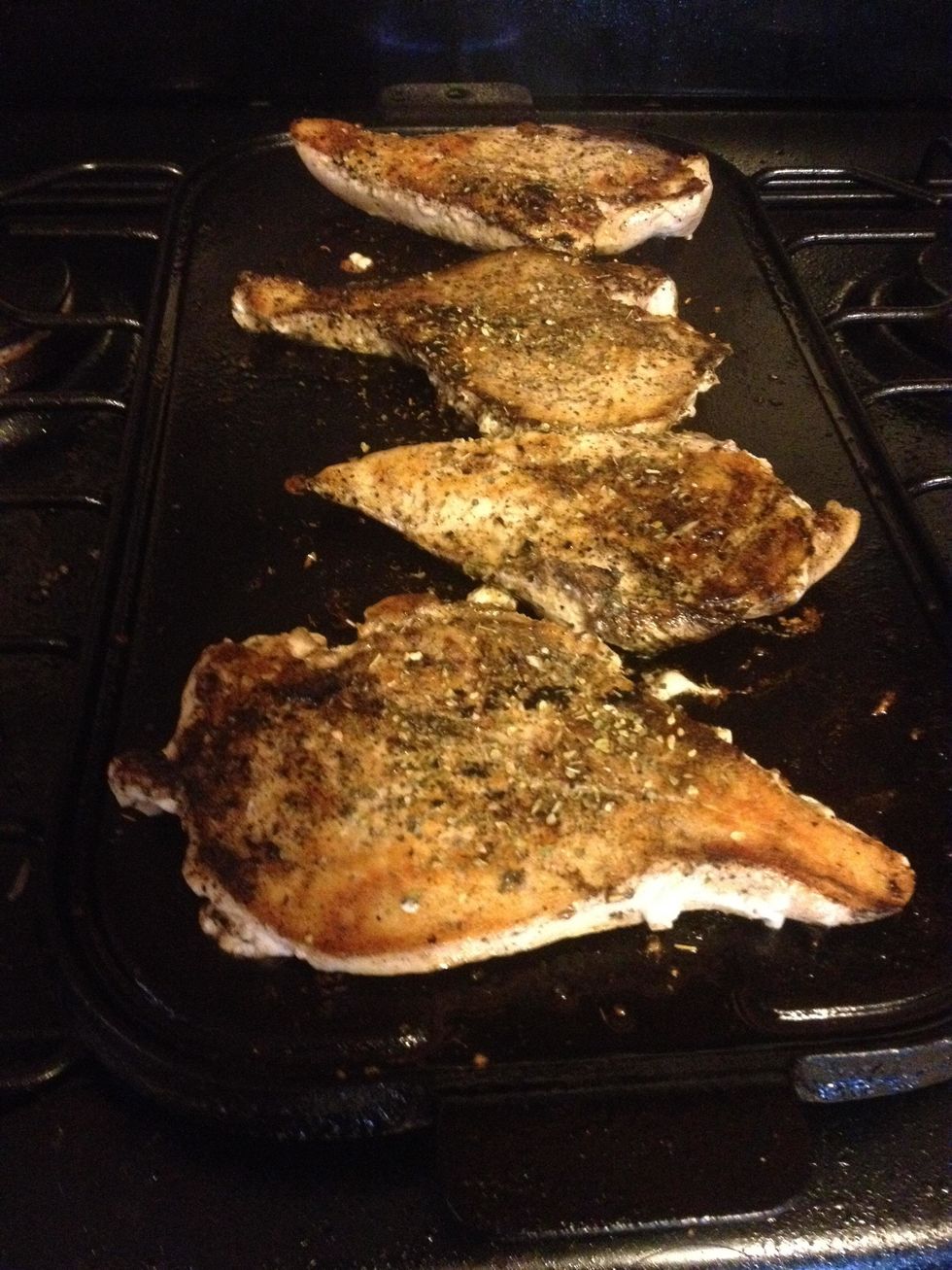 Sprinkle with Italian seasoning, and grill on seasoned grill or BBQ for about 5 min each side. The chicken will not be cooked through. That's OK, we will be baking